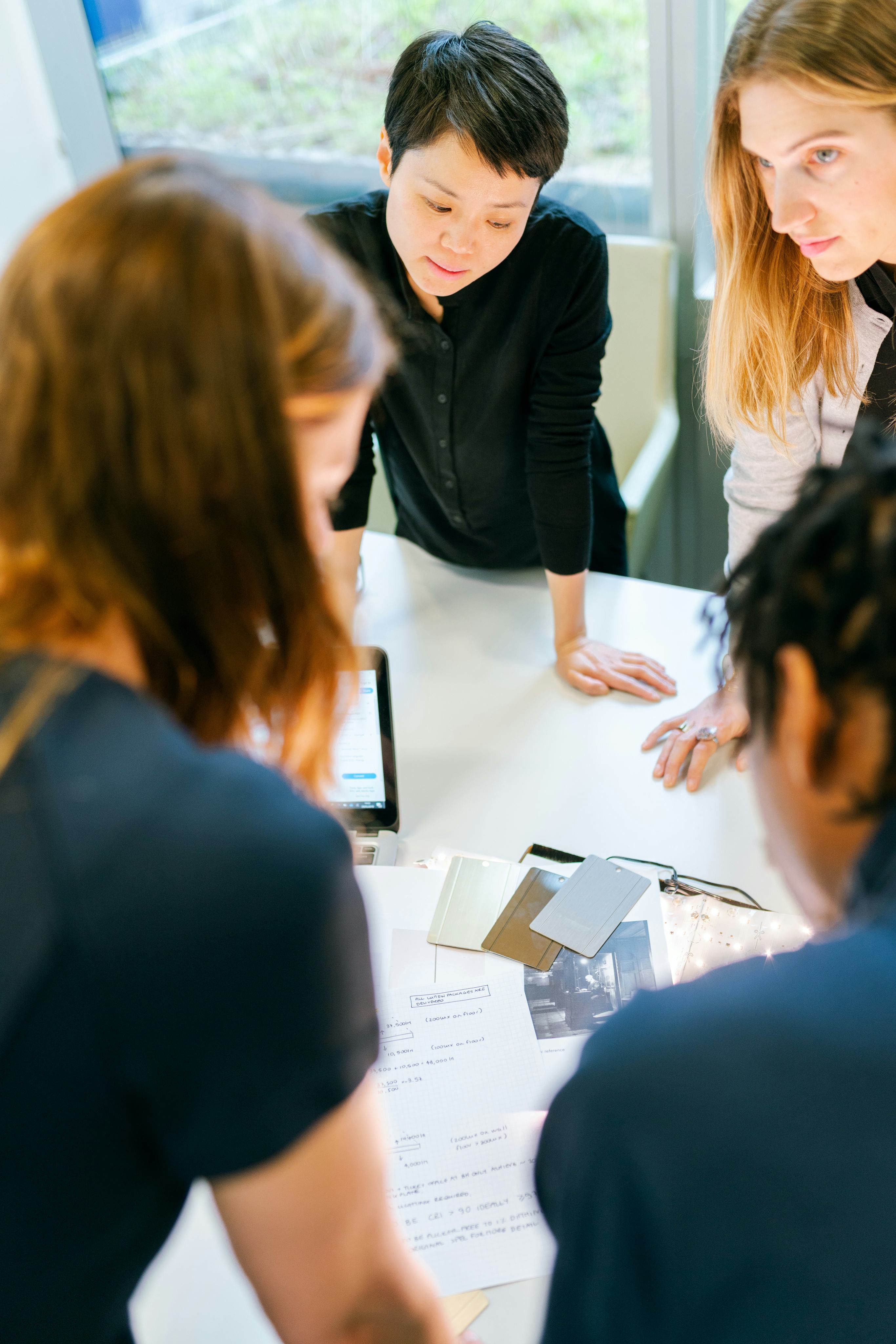 Colleagues leaning in together around a table